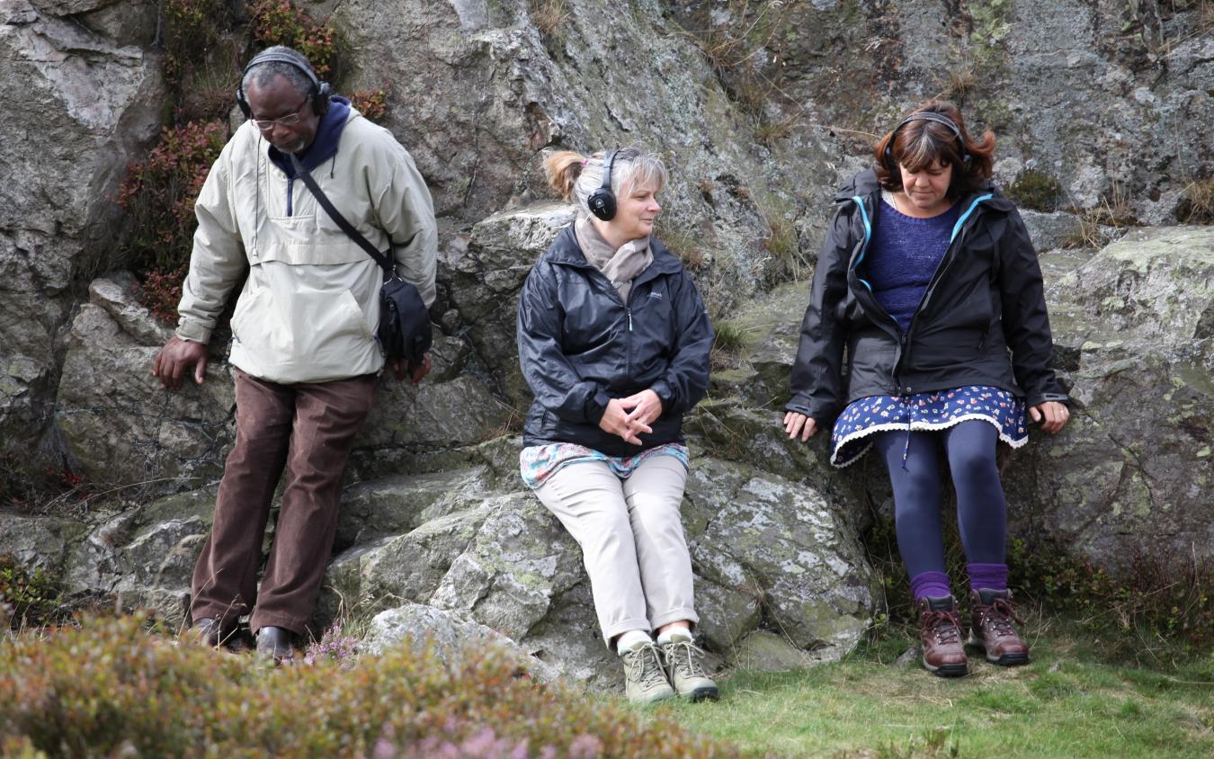 In This Place - Group Listening on a rock