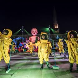 Mind the Gap photo of 3 men in yellow spacesuits on stage