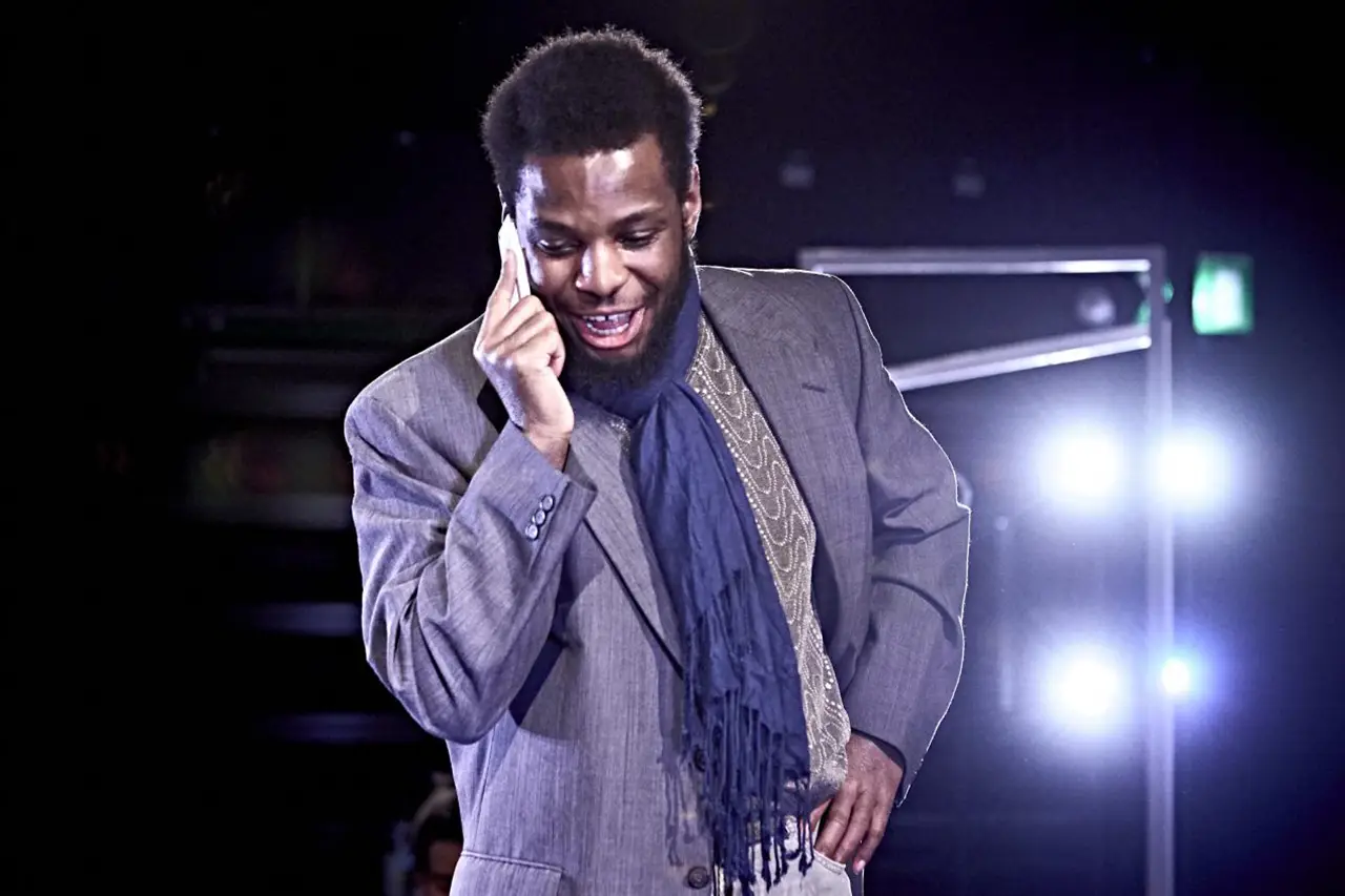 Man in suit smiling on stage