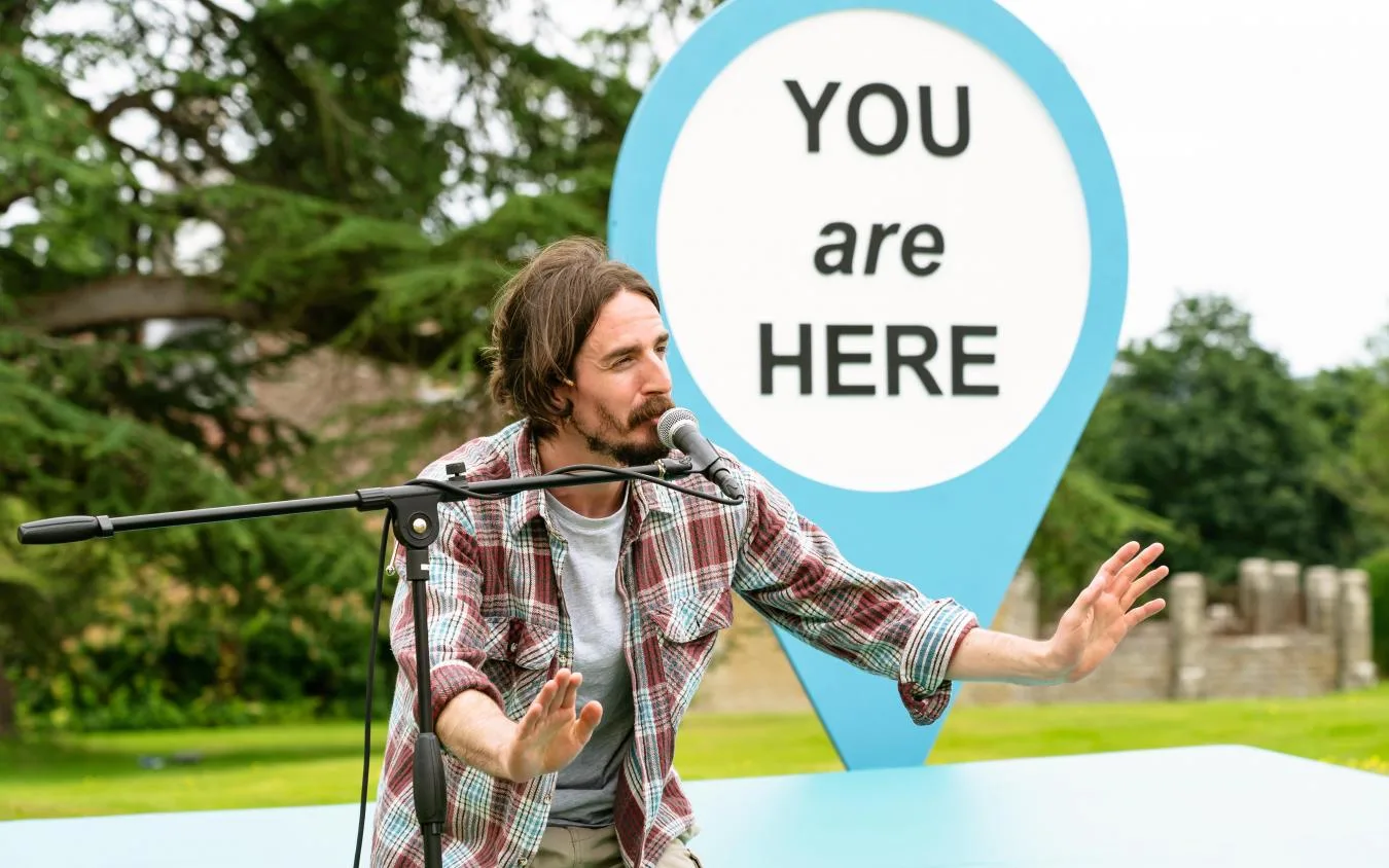 Man performing with microphone outdoors.