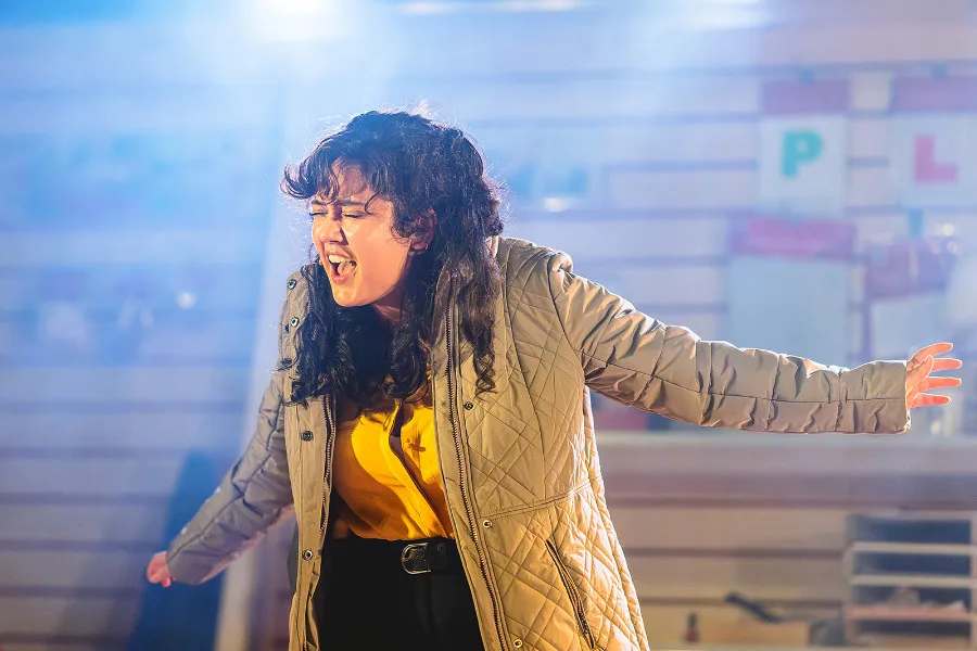 Woman performing passionately on stage